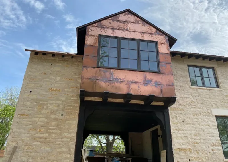 Copper metal panel facade on a stone building for Skylight Installation in Winter Park